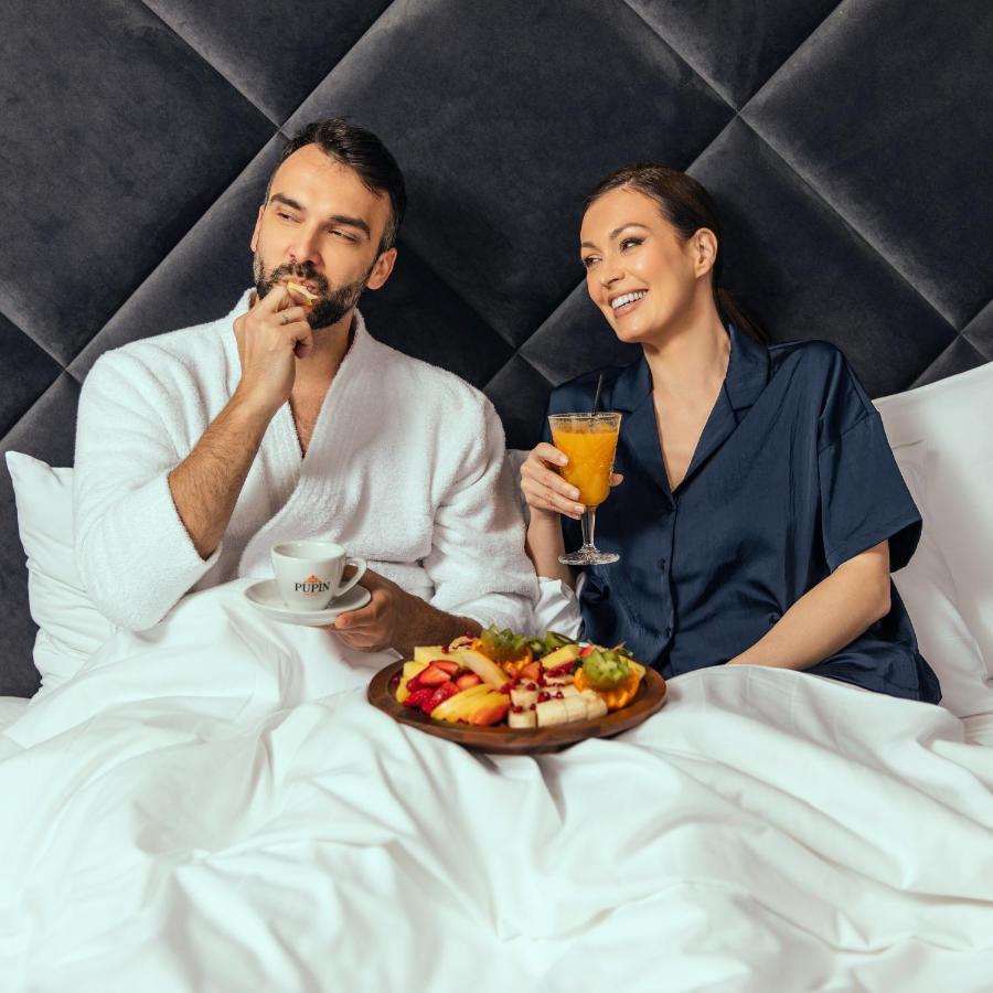 Hotel Pupin Novi Sad Exterior foto A couple having breakfast in bed